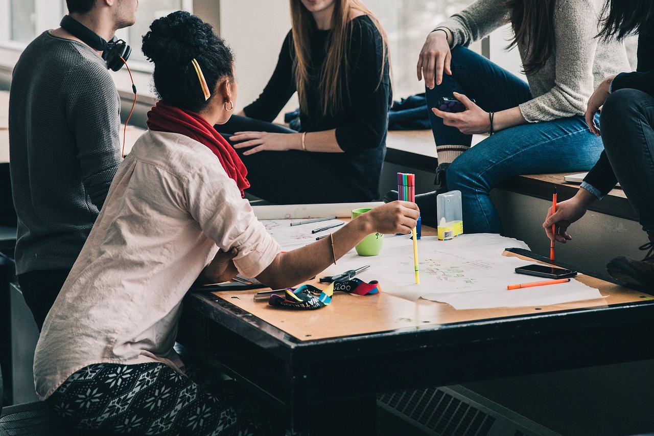 diverse group of people sitting around a table in an office environment